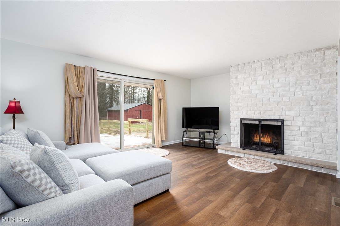 7317 Beach Road Wadsworth, OH 44281 - Photo 5 of 42 Living room featuring wood-type flooring and a brick fireplace
