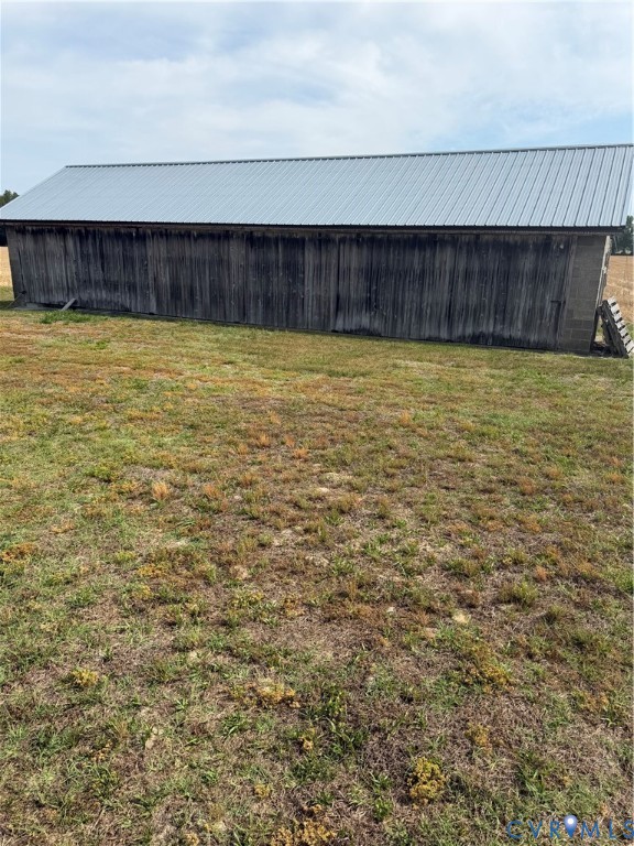 9380 Wakefield Road Wakefield, VA 23888 - Photo 9 of 11 Outbuilding featuring a metal roof and vertical bo