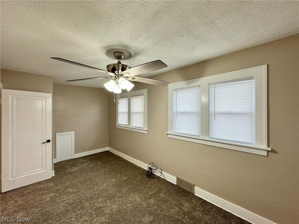 507 Canton Road Wintersville, OH 43953 - Photo 31 of 45 Carpeted spare room with a textured ceiling and ceiling fan