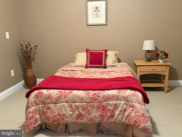 a bedroom with a bed and a lamp