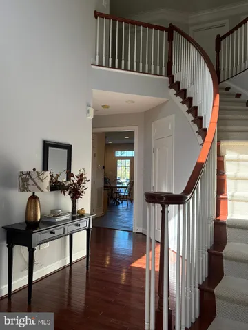 a view of entryway livingroom and hall with wooden floor