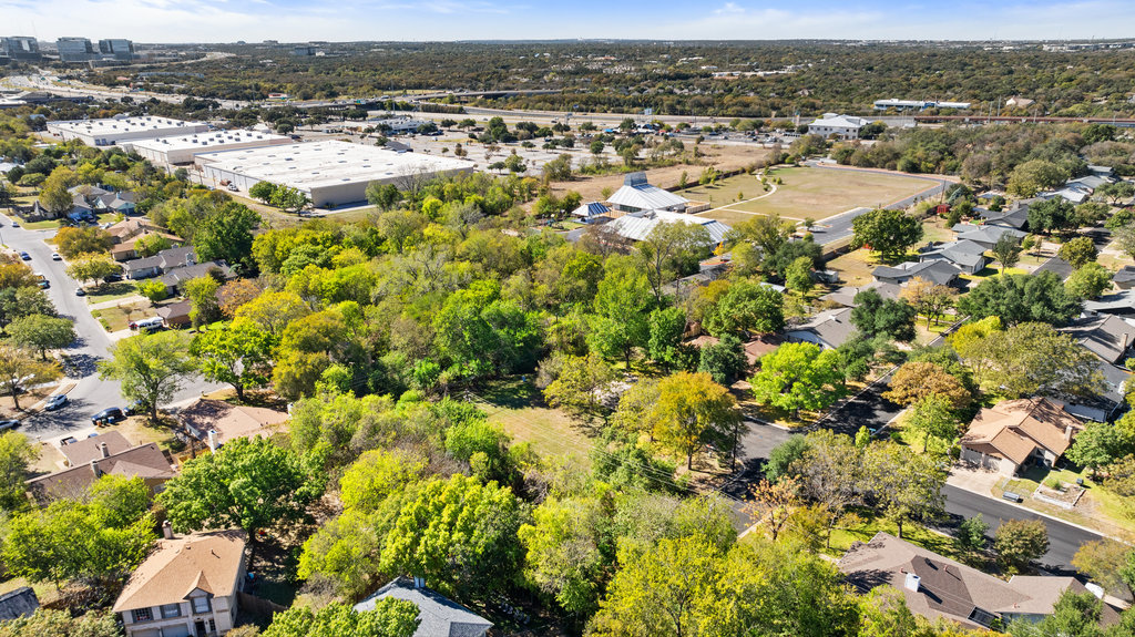 13003 Winwick Way Austin, TX 78727 - Photo 5 of 24 Aerial view of residential area with a tree filled landscape