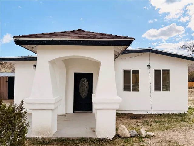 a front view of a house with white door