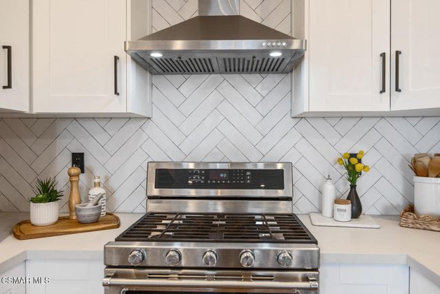 a dining room with furniture potted plants and wooden floor