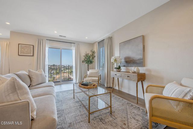 a bedroom with a large bed and a large window