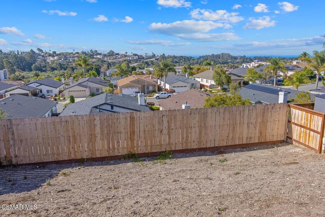 a view of a swimming pool with a table and chairs a barbeque and wooden floor