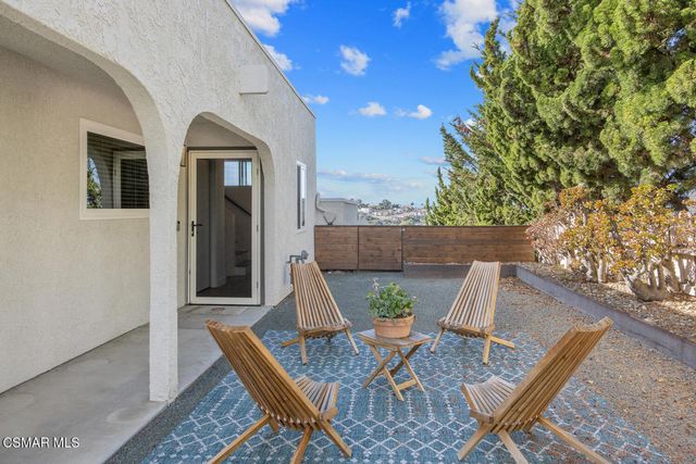 a kitchen with white cabinets and appliances