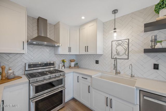 a kitchen with a stove and cabinets