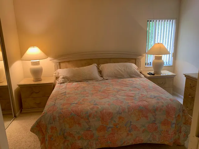 a bedroom with a bed and a lamp
