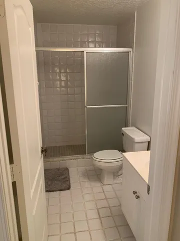 a bathroom with a toilet and a shower