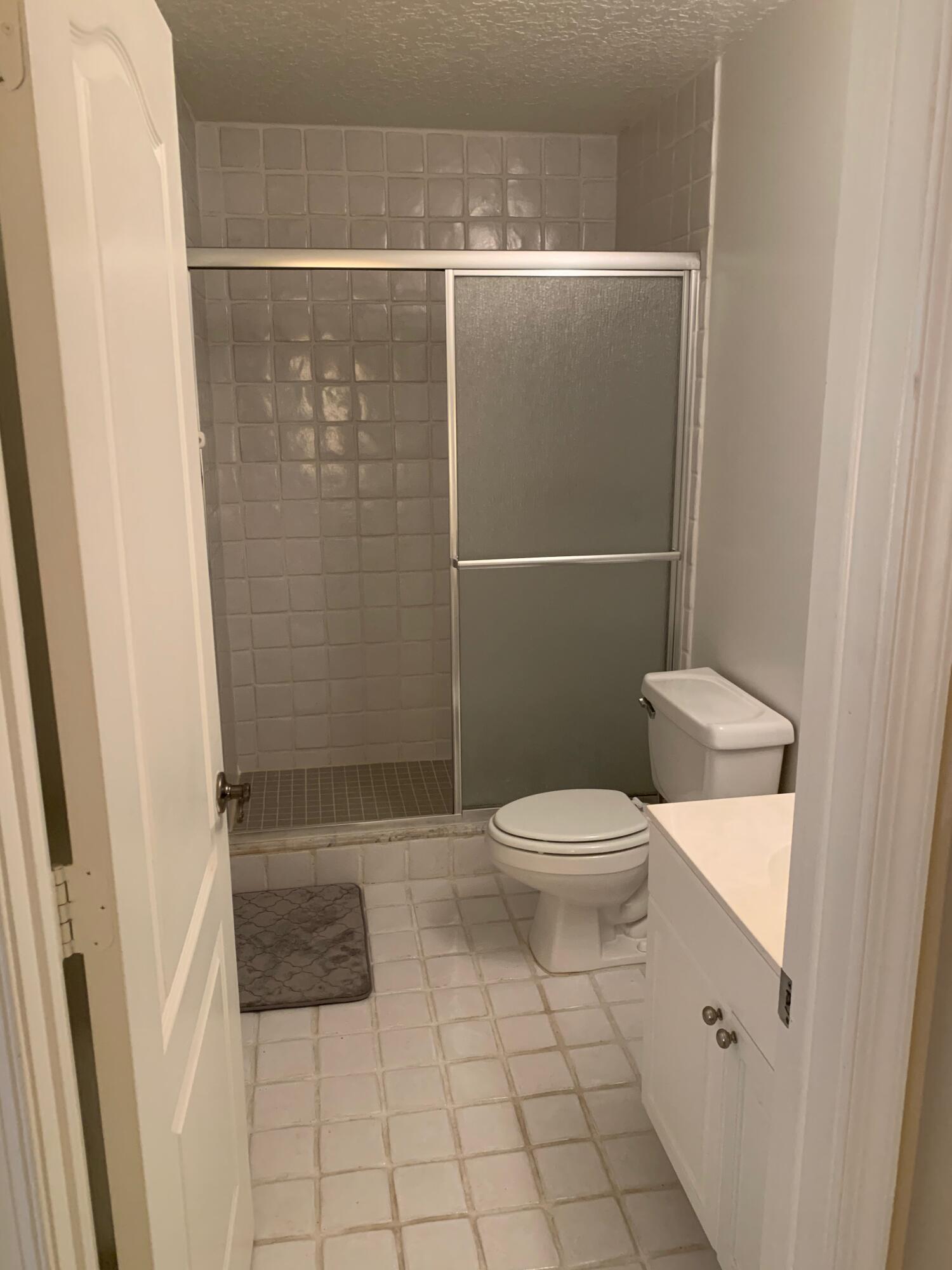 49 Uno Lago Drive Juno Beach, FL 33408 - Photo 12 of 18 a bathroom with a toilet and a shower