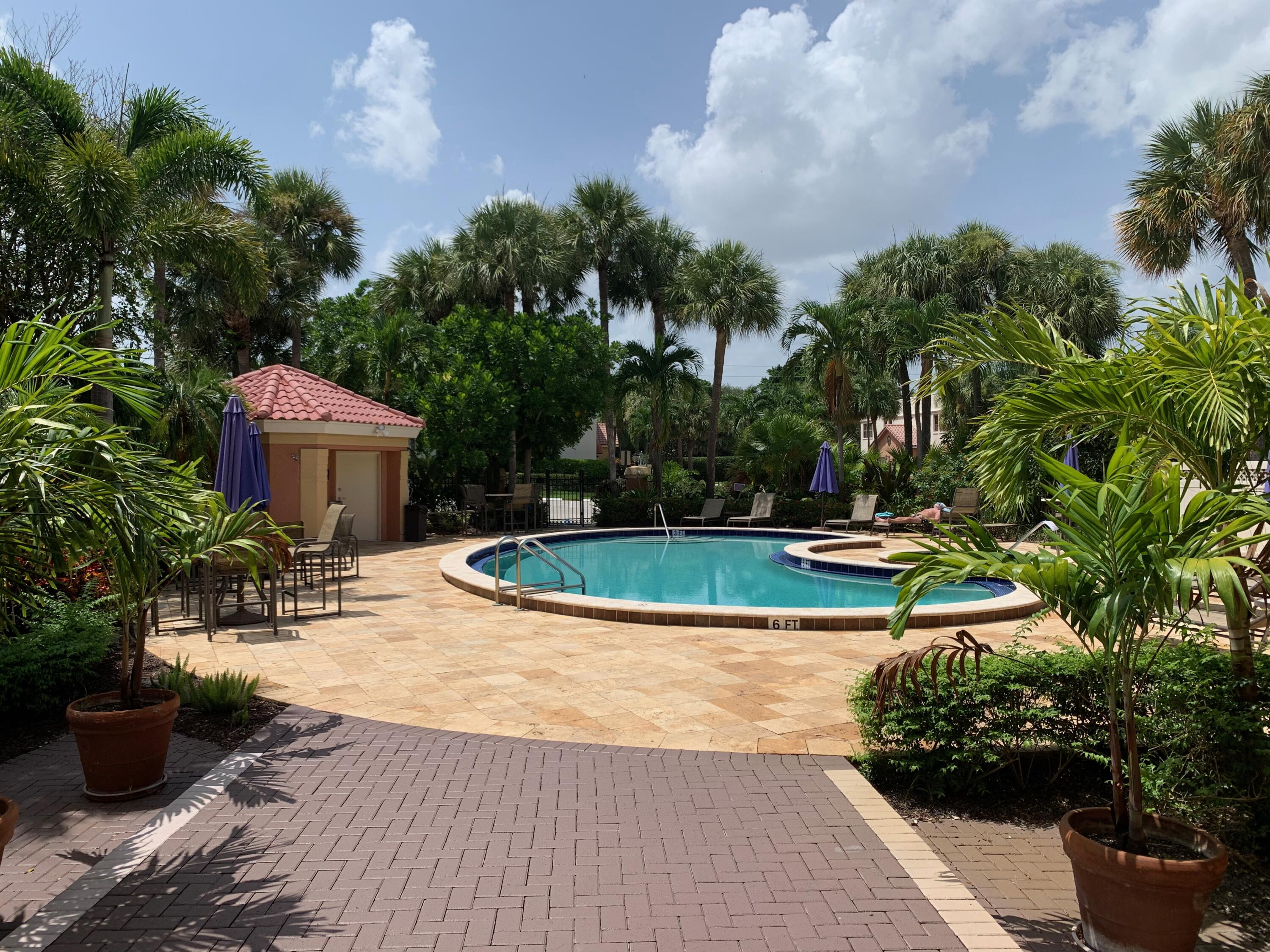 49 Uno Lago Drive Juno Beach, FL 33408 - Photo 15 of 18 a view of a backyard with sitting area