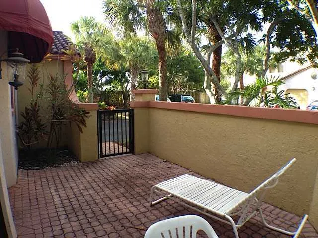 a view of balcony with wooden floor and outdoor seating