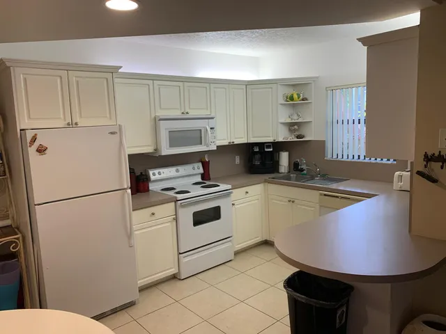 a kitchen with a sink appliances and cabinets
