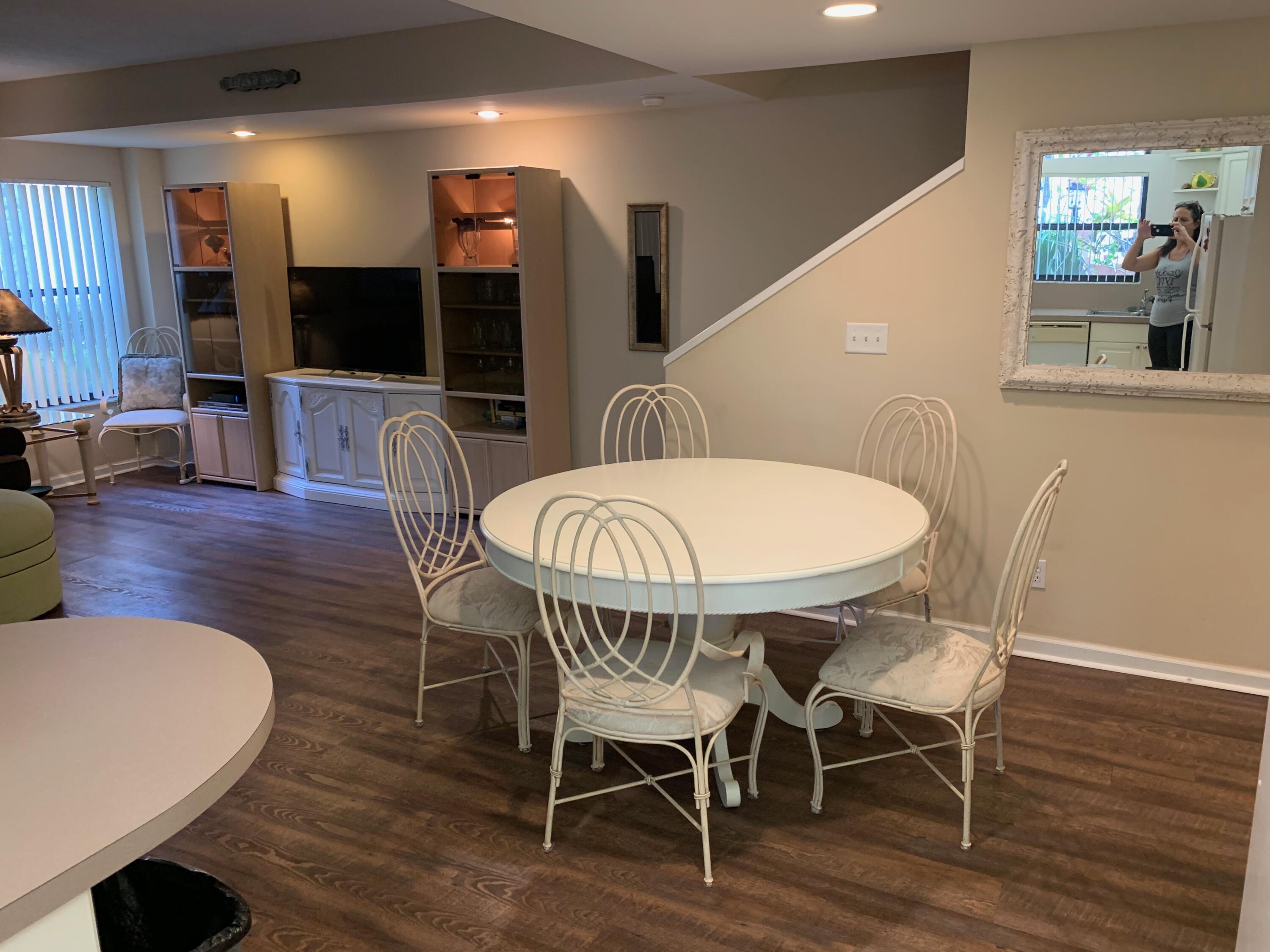 49 Uno Lago Drive Juno Beach, FL 33408 - Photo 5 of 18 a dining room with furniture kitchen view and a wooden floor