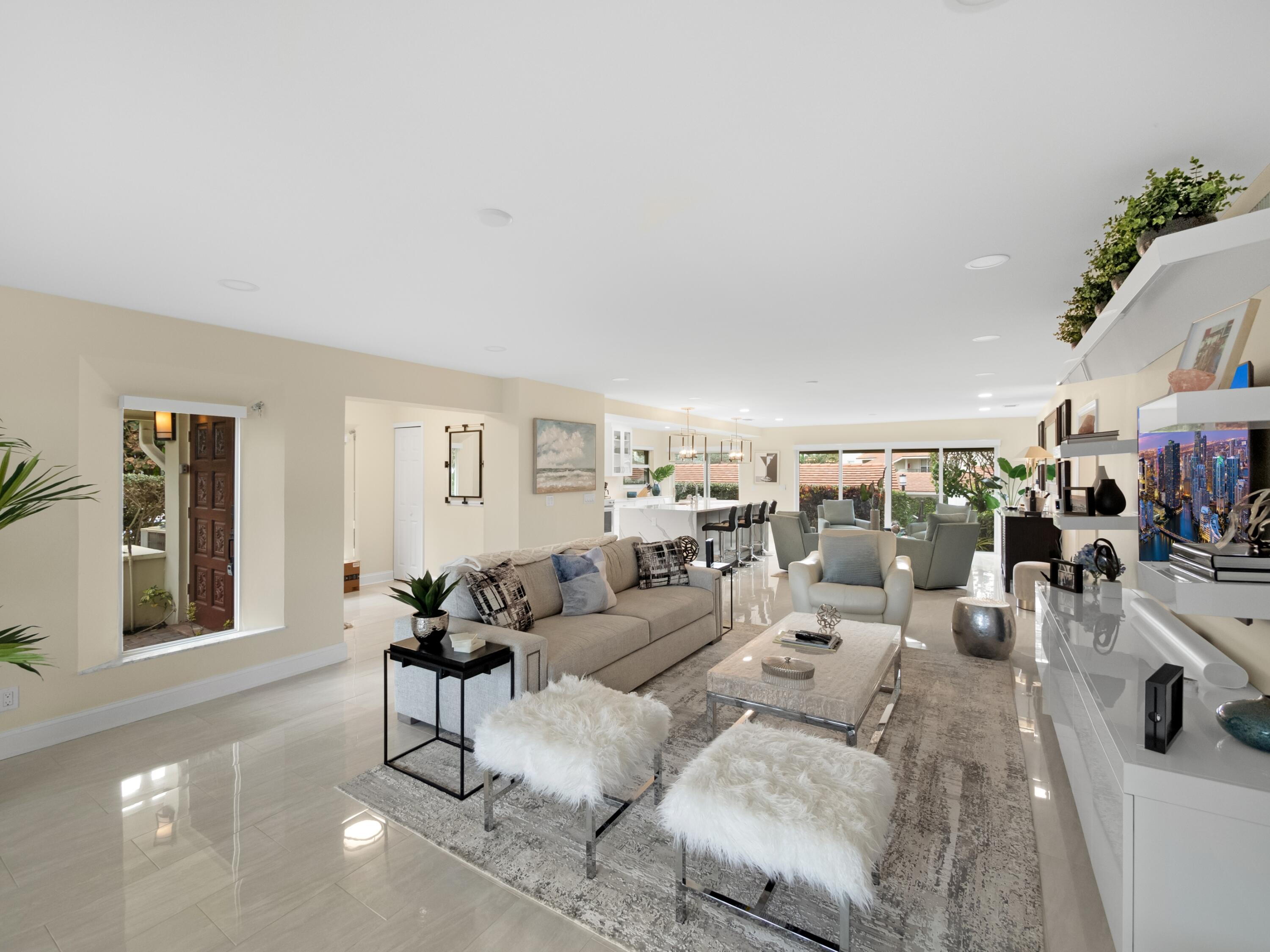 4161 U.S. Highway 1, Unit N1 Jupiter, FL 33477 - Photo 15 of 18 a living room with lots of furniture and white walls