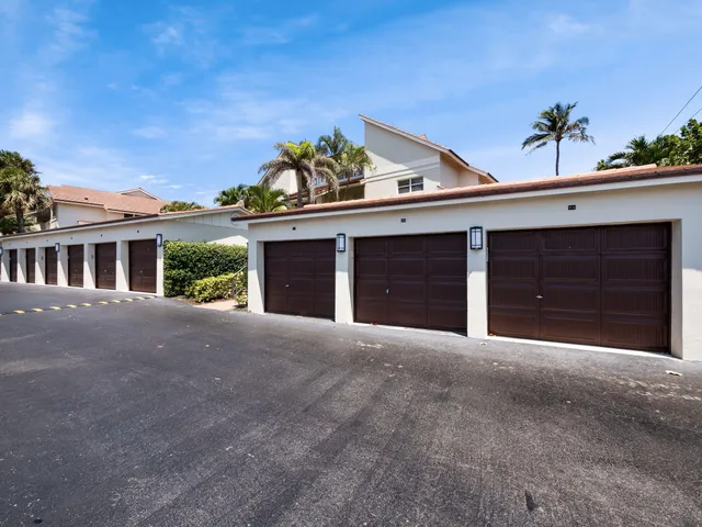a view of a house with a big yard and large trees