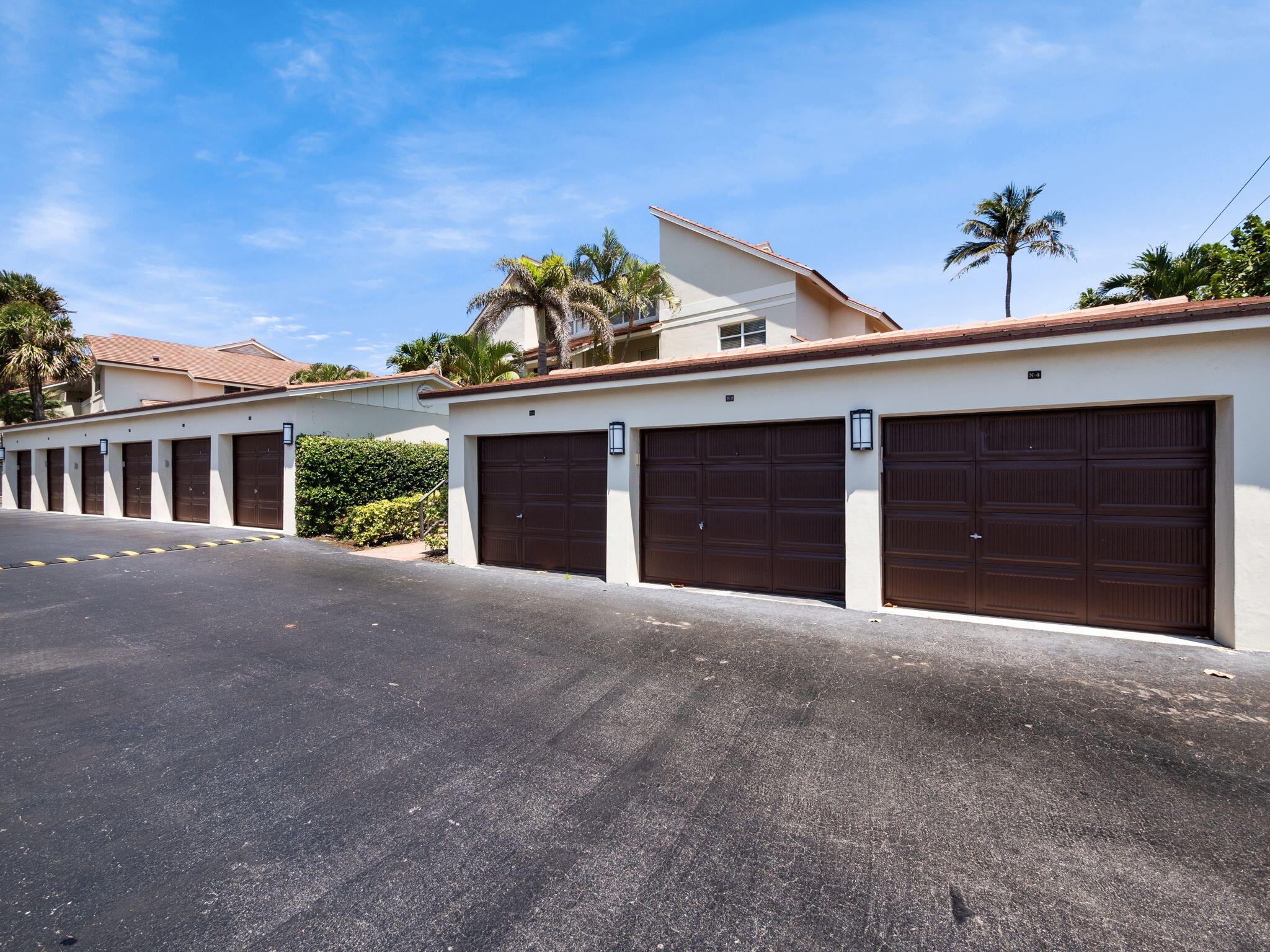 4161 U.S. Highway 1, Unit N1 Jupiter, FL 33477 - Photo 16 of 18 a front view of a house with a yard and garage