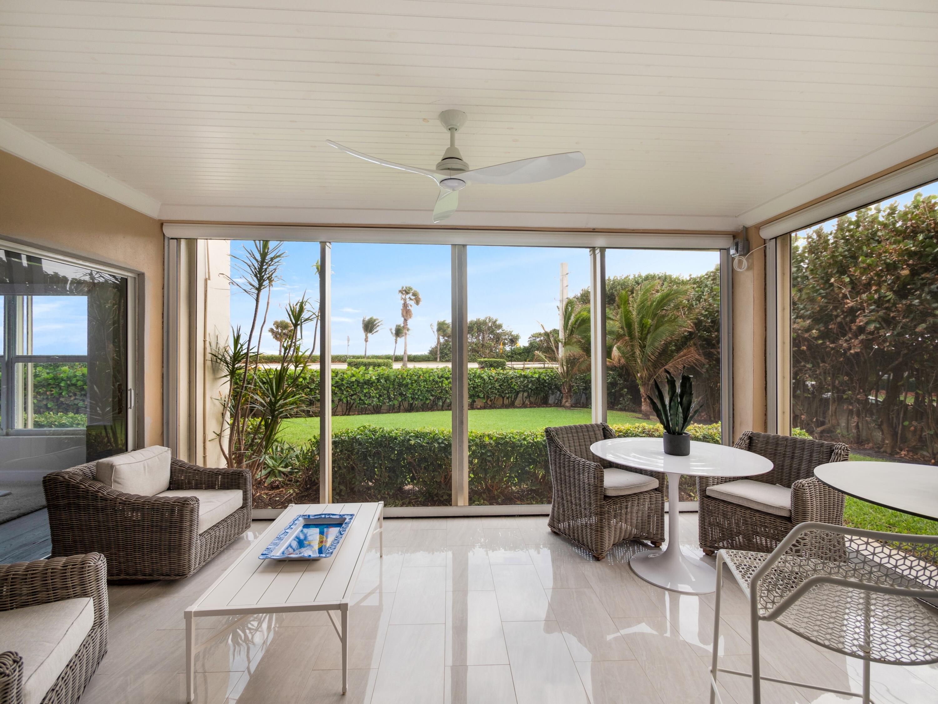 4161 U.S. Highway 1, Unit N1 Jupiter, FL 33477 - Photo 4 of 18 a living room with furniture and a floor to ceiling window