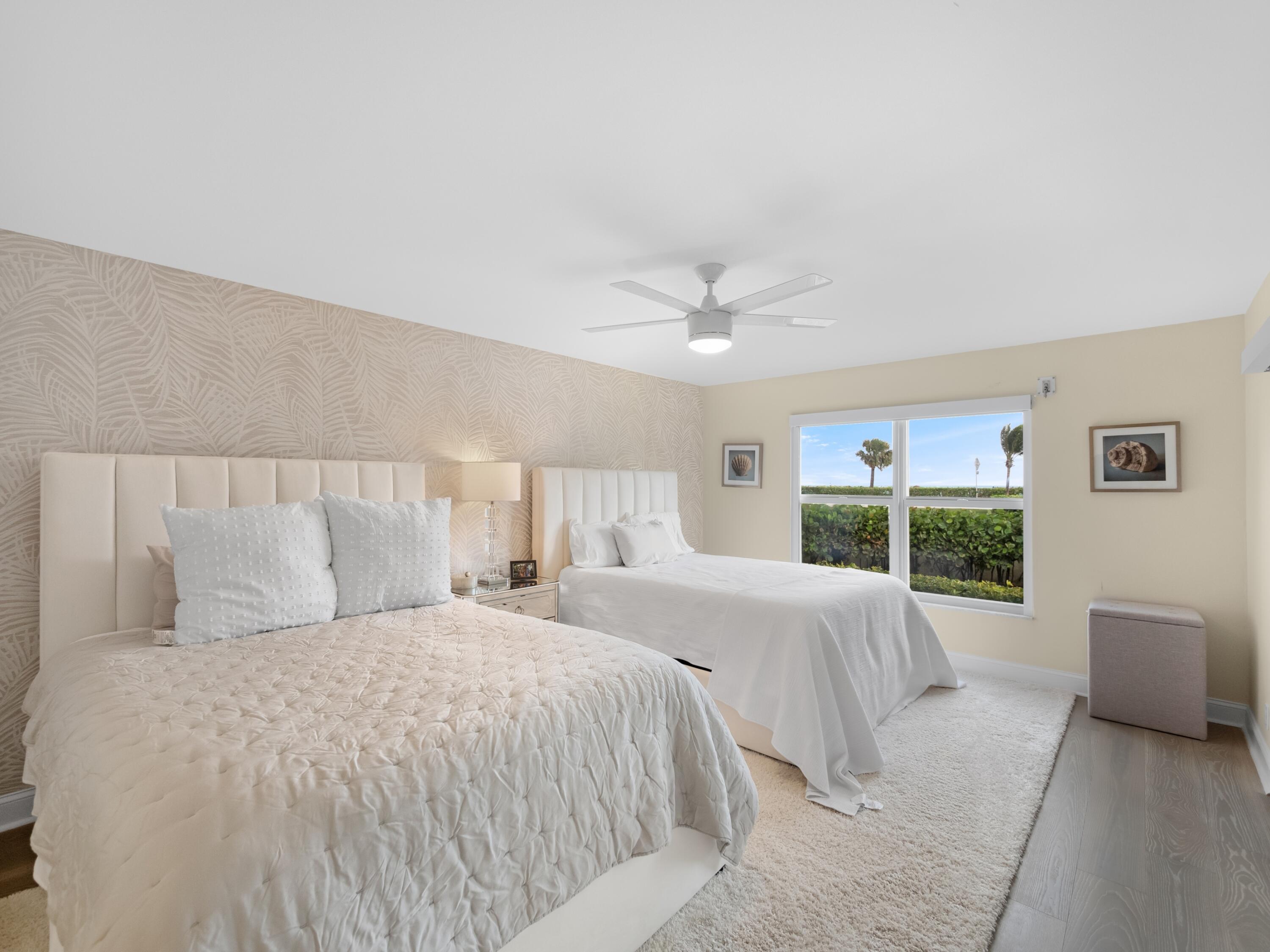 4161 U.S. Highway 1, Unit N1 Jupiter, FL 33477 - Photo 9 of 18 a bedroom with a large bed and a chandelier