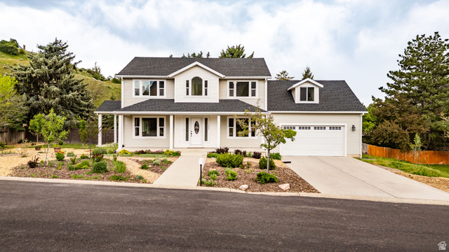 1552 Sumac Drive Logan, UT 84321 - Photo 72 of 72 Two-story residence featuring a light-colored facade, dark shingle roof, and an attached two-car garage