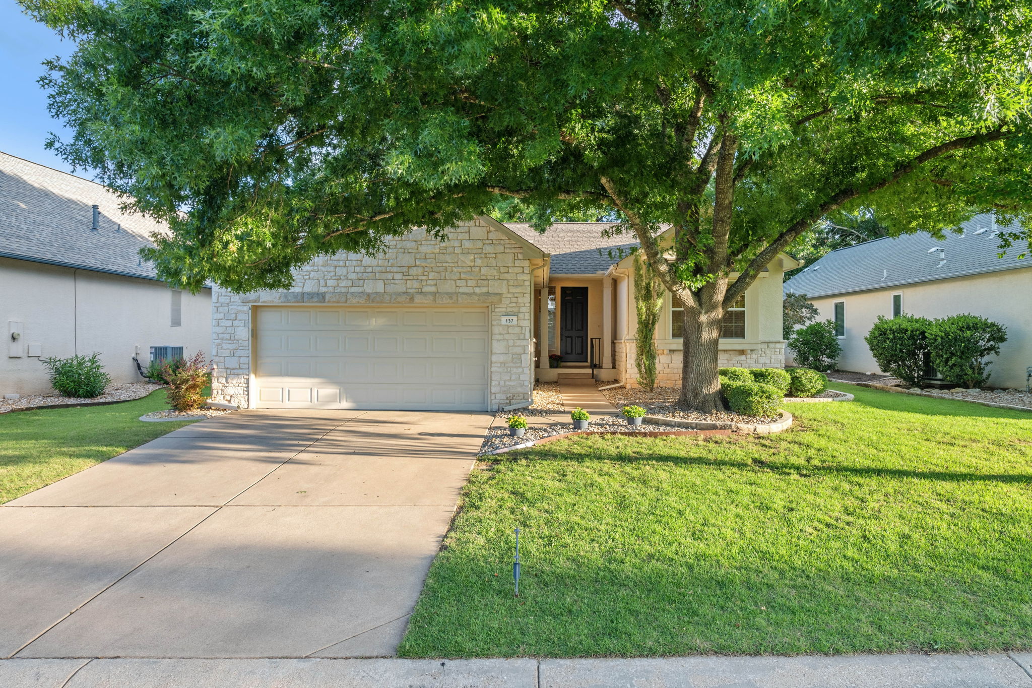 137 Trail Rider Way Georgetown, TX 78633 - Photo 25 of 29 Mature trees and neat landscaping enhance the curb appeal of this charming stone-accented home.