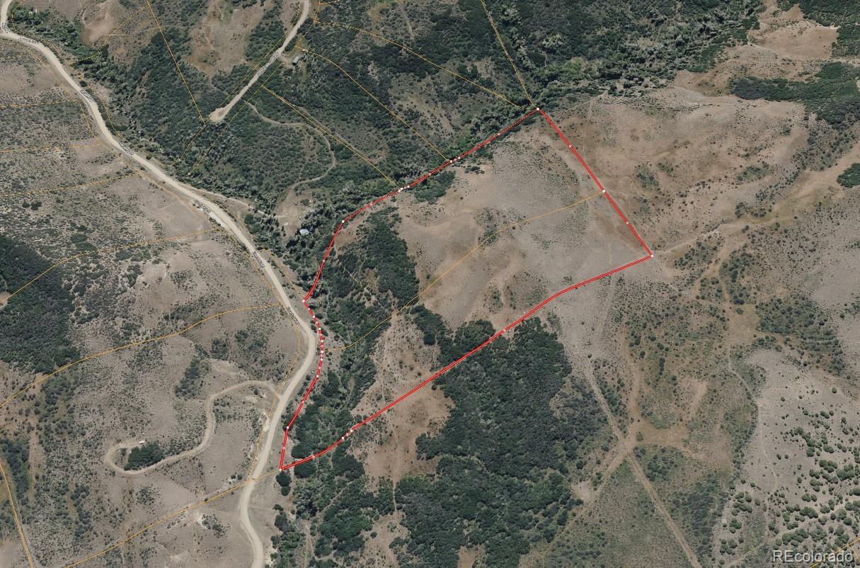 164 Granite Road Craig, CO 81625 - Photo 2 of 4 a view of a dry yard with trees and stairs