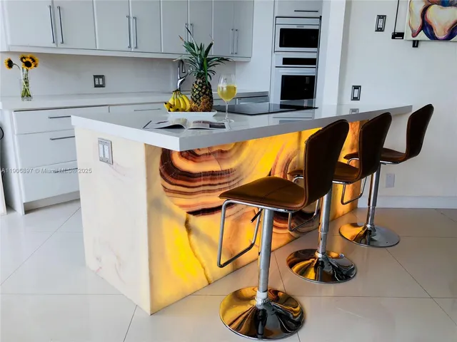 a kitchen with a sink cabinets and appliances