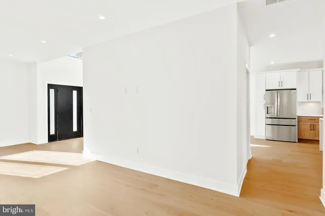a view of a kitchen with a sink and a refrigerator
