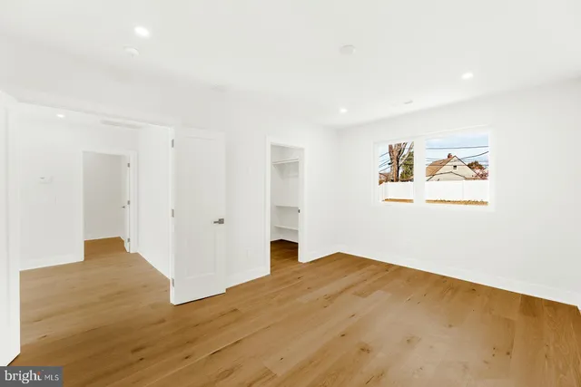 a view of a livingroom with wooden floor and a ceiling fan