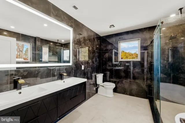 a bathroom with a sink double vanity and a mirror