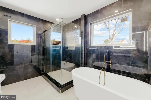 a bathroom with a tub shower and sink