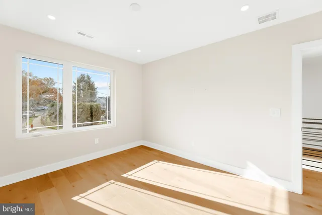 a view of a room with wooden floor and a window