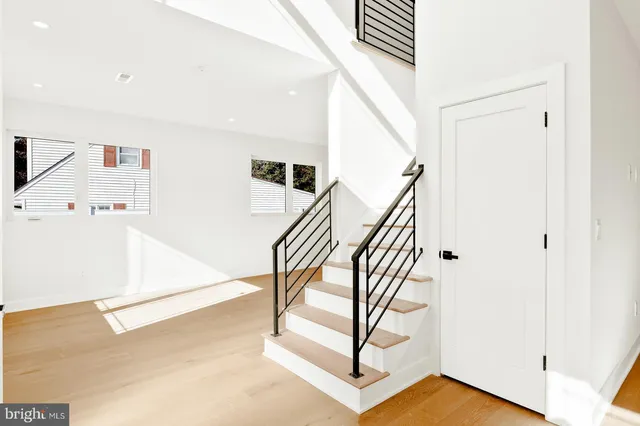 a view of entryway and hall with wooden floor