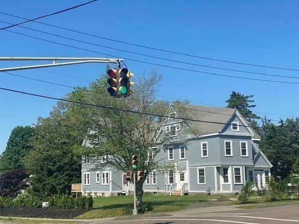 a view of a big house with a street