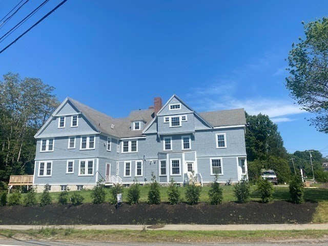 25 Ripley Road, Unit 1 Cohasset, MA 02025 - Photo 13 of 14 a front view of a house with a yard