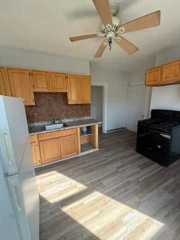 a kitchen with a stove a sink and a refrigerator