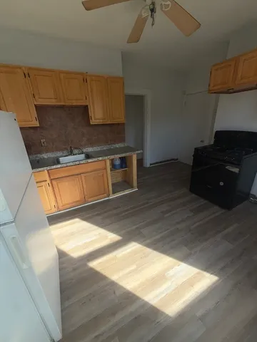 a kitchen with stainless steel appliances granite countertop a sink stove and cabinets