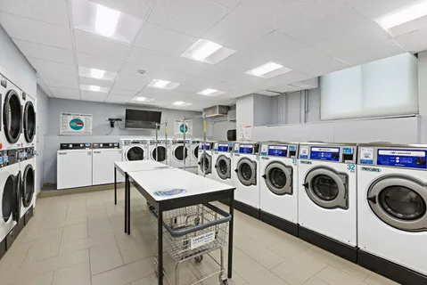 a utility room with dryer washer and a view of kitchen