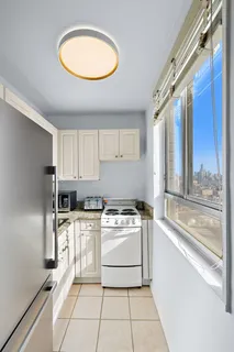 a kitchen with a stove a sink and a refrigerator