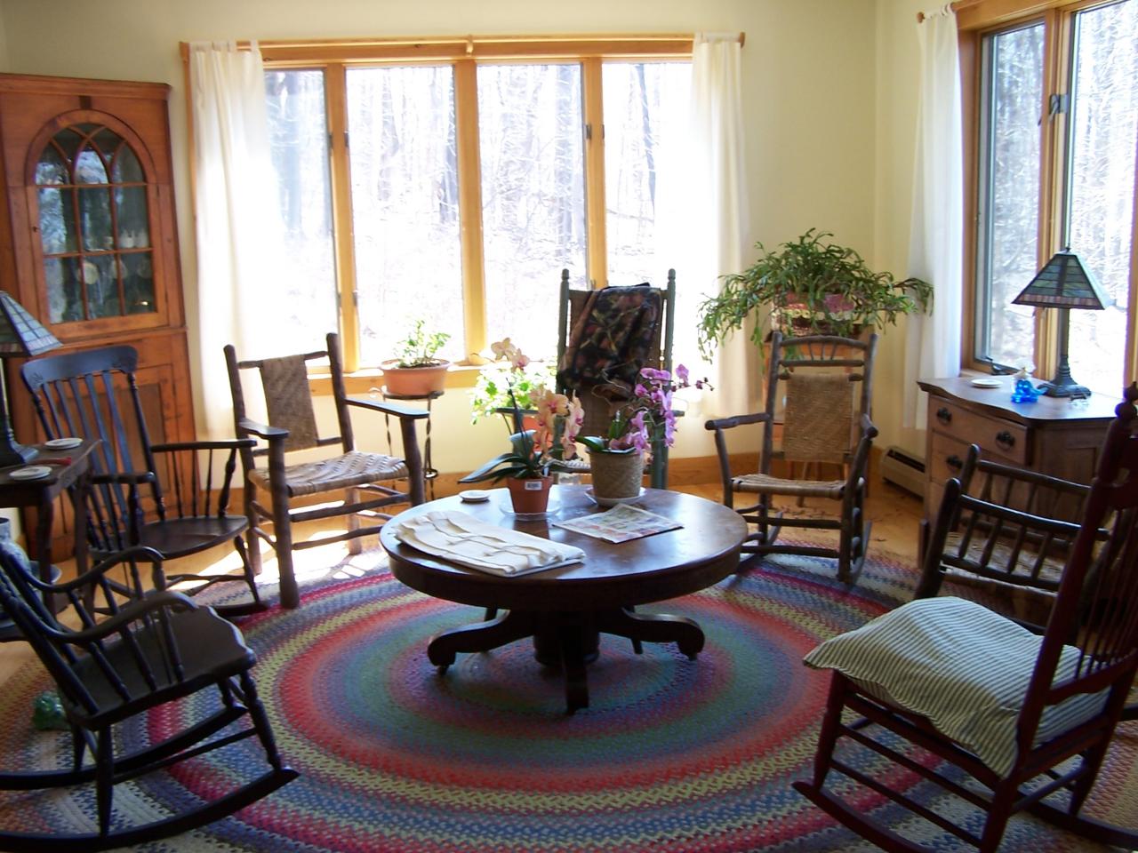 1330 Jacobs Ladder Road Becket, MA 01223 - Photo 3 of 15 a living room with furniture a flat screen tv and a floor to ceiling window