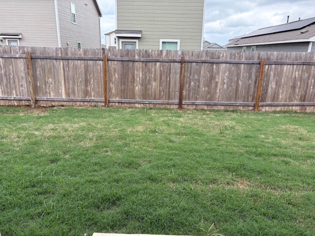 147 Gabbro Gardens Maxwell, TX 78656 - Photo 14 of 14 Expansive grass lawn with a wood plank fence