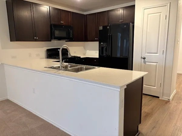 a kitchen with a sink and a refrigerator