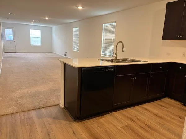 a kitchen with a sink and a mirror
