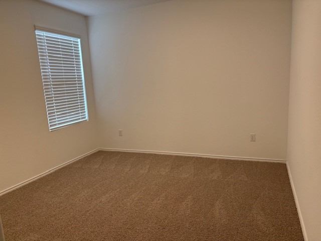 147 Gabbro Gardens Maxwell, TX 78656 - Photo 9 of 14 Carpeted room featuring a single window with blinds and light-toned walls
