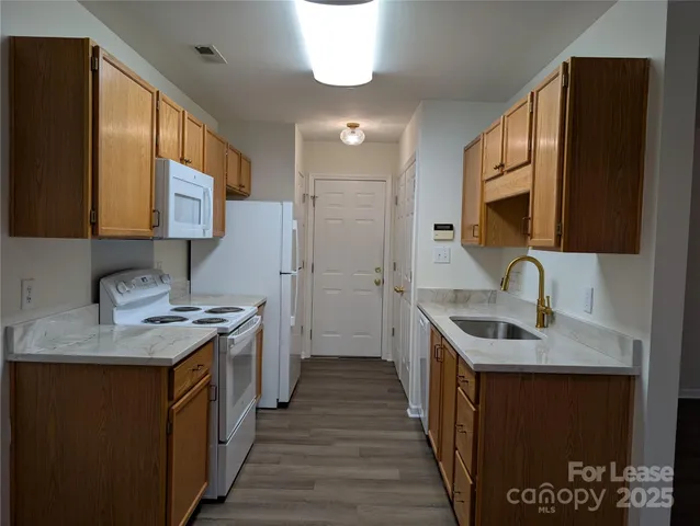 a kitchen with a sink stove and cabinets