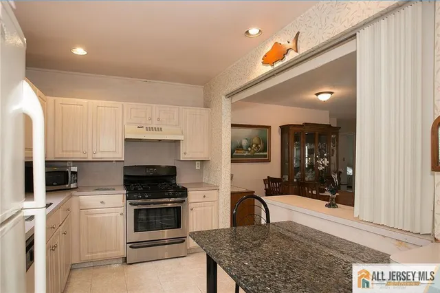 a kitchen with a stove and a refrigerator
