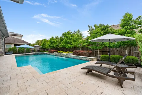 a view of a swimming pool with a patio
