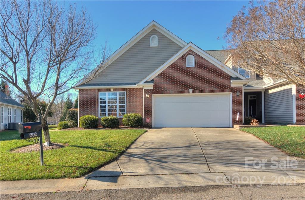 302 Garnet Court, Unit 522 Fort Mill, SC 29708 - Photo 2 of 45 a front view of a house with a yard and garage