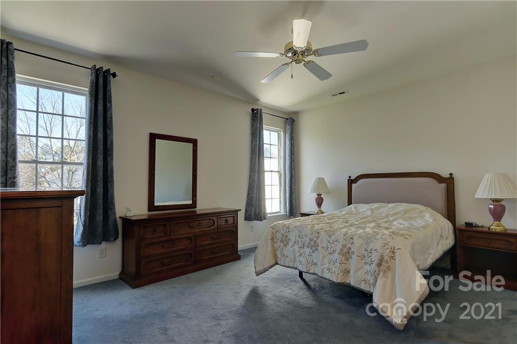 302 Garnet Court, Unit 522 Fort Mill, SC 29708 - Photo 22 of 45 a bedroom with a bed dresser and a window